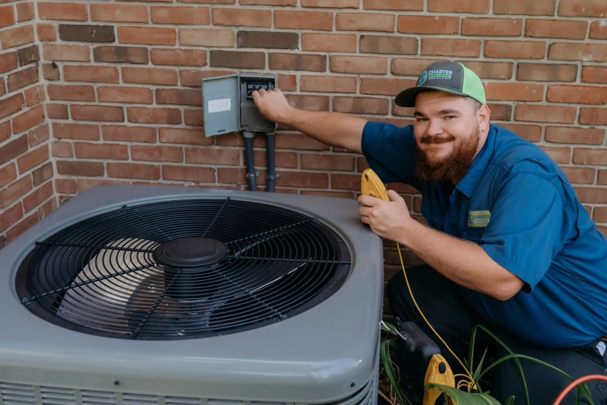 A charter home comfort worker installing an AC  
